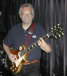 Doc Robin on stage with his Les Paul guitar